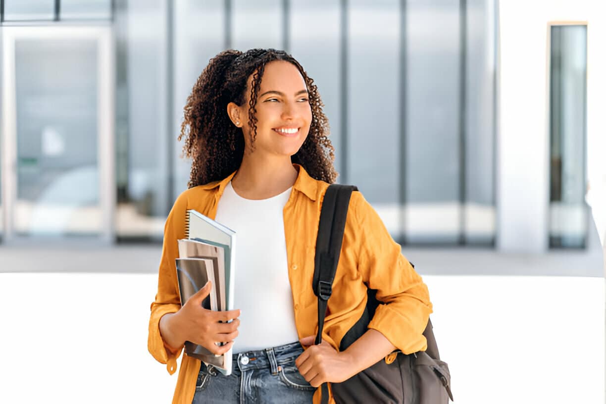 A person smiling because she enrolled in ESL classes in Houston